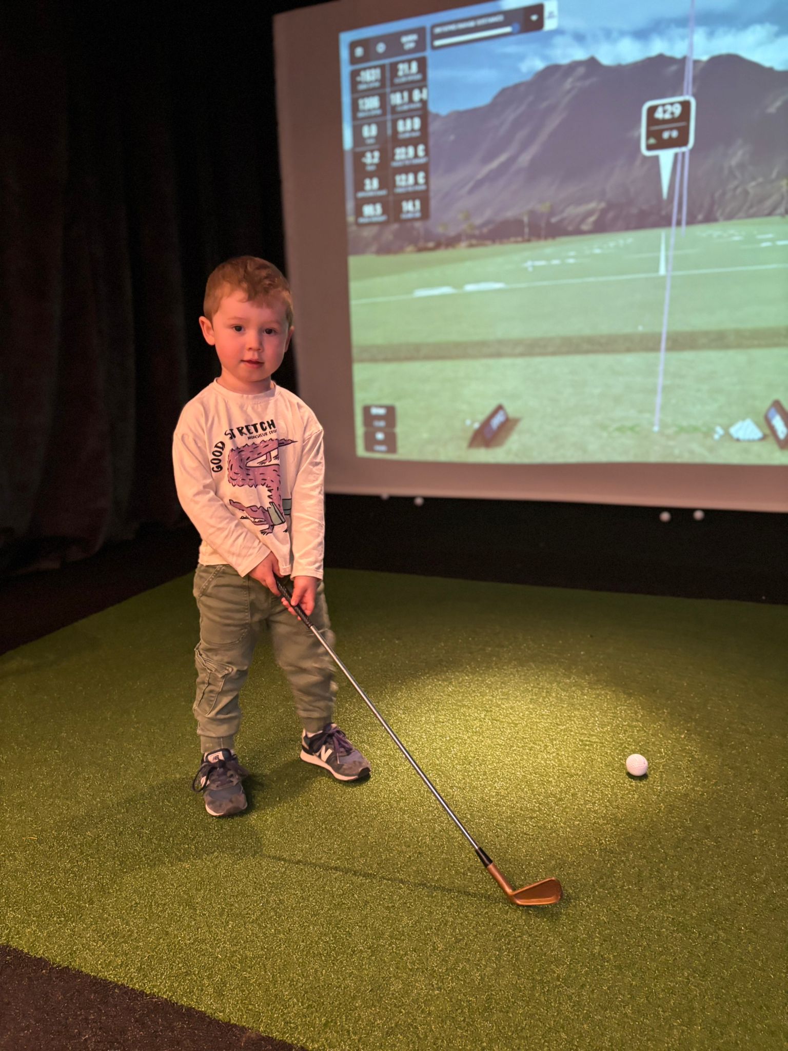 A young guest lining up a shot on The Knights Club simulator